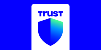 Close-up of a hardware wallet with city skyline in the background