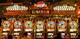 Gamblers sitting in front of slot machines in Harrah's Casino on the ...